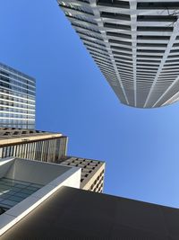 Low angle view of buildings against clear blue sky