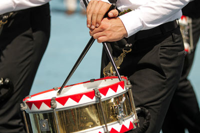 Midsection of men with drums