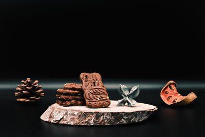 Close-up of cookies on table against black background