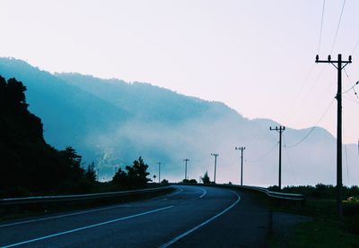 Road by mountain against sky