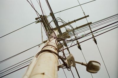 Low angle view of electricity pylon against sky