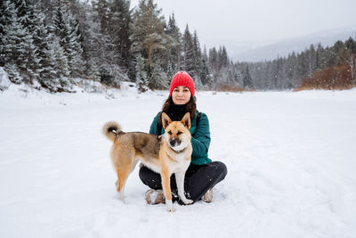 Dog running on snow covered field