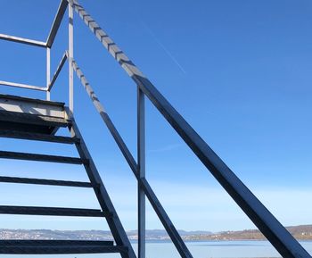 Low angle view of metallic structure against clear blue sky