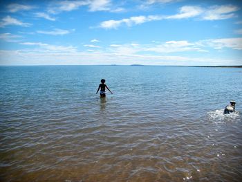 Man surfing in sea against sky