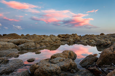 Scenic view of rocks against sky during sunset