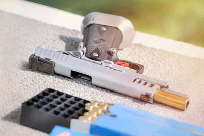 Close-up of hand gun on table