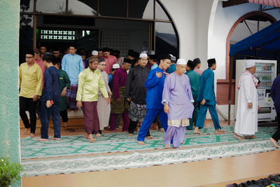 Rear view of people walking in city