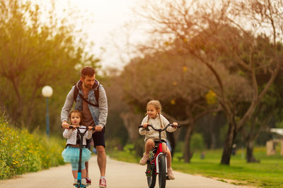 Father with daughters enjoying at park