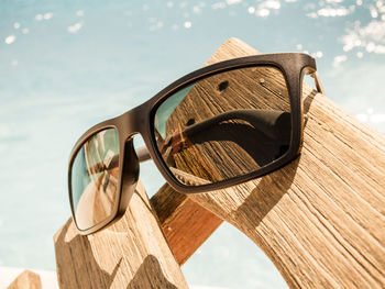 Close-up of sunglasses against sky