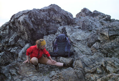 Rear view of person on rock by mountains
