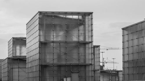 Low angle view of industrial building against sky