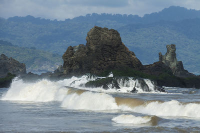 Scenic view of sea and rocks against sky