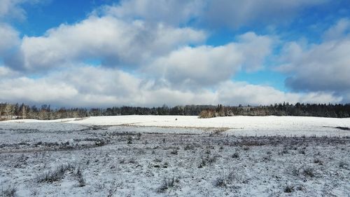 Scenic view of landscape against sky during winter