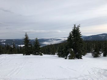 Snow covered landscape against sky