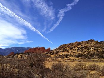 Scenic view of vapor trail against blue sky