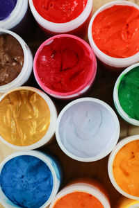 Full frame shot of colorful paints in containers