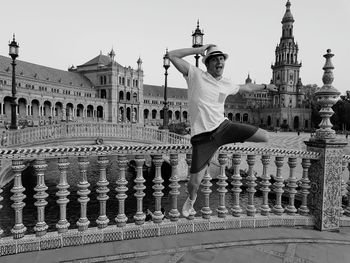 Portrait of cheerful young man jumping in city