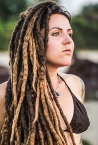 Young woman with dreadlocks looking away