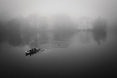 Scenic view of river against sky during foggy weather