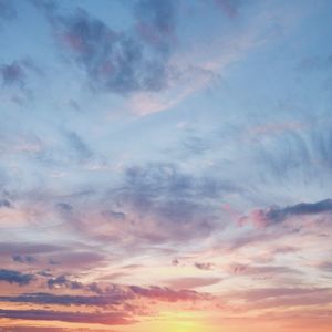 Low angle view of cloudy sky at sunset