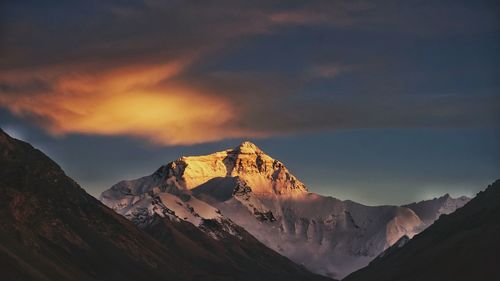 Scenic view of snowcapped mountains against sky during sunset