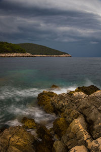 Scenic view of sea against cloudy sky