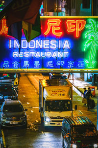 Illuminated sign on street in city at night