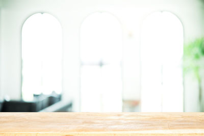 Close-up of white table against wall