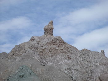 Low angle view of rock formations against sky