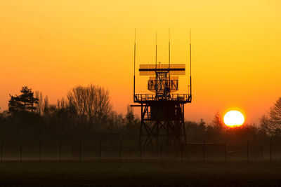 Silhouette tower against sky during sunset