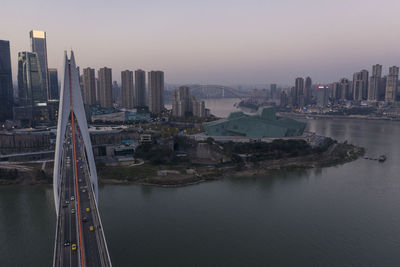 Aerial view of chongqing at sunset with qiansimen bridge and grand theatre on foreground