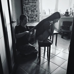 Woman sitting on chair at home