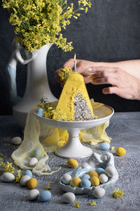 Traditional easter orthodox curd cake with yellow flowers on a grey table