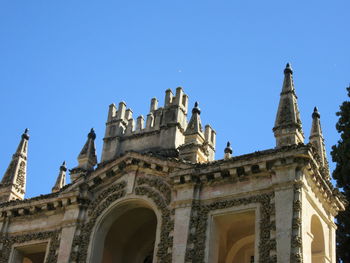 Low angle view of historic building against clear blue sky