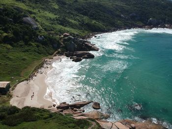 High angle view of rocks by sea