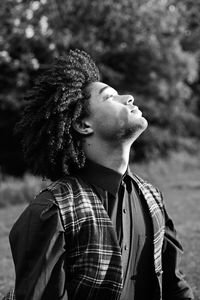 Portrait of young man looking away outdoors