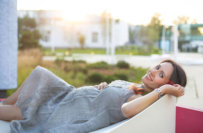 Side view of smiling young woman lying down