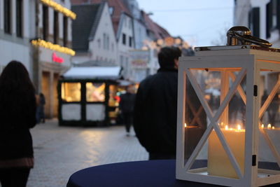 Close-up of illuminated lighting equipment on table in city