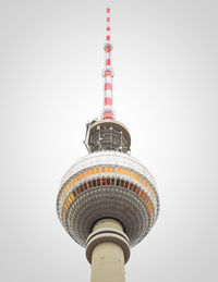 Low angle view of communications tower against sky in city