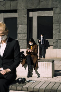 Business people with face masks keeping social distance