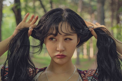 Close-up of woman holding hair