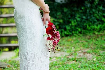 Close-up of hand holding white flower