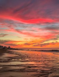 Scenic view of sea against dramatic sky during sunset