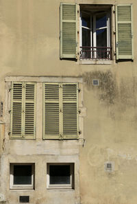 Low angle view of windows on wall of building