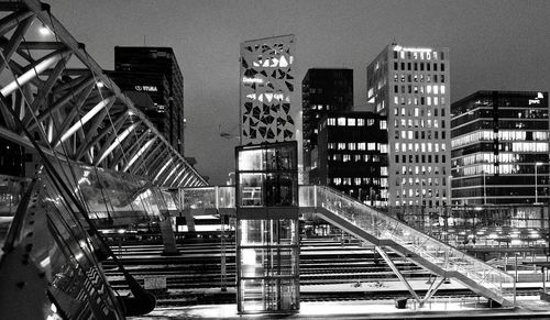Illuminated city against sky at night