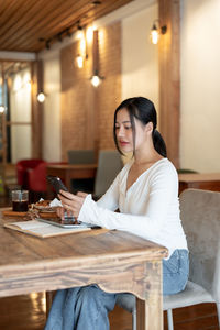 Young woman sitting on table