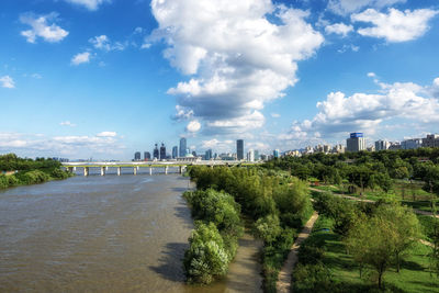 Scenic view of trees and buildings against sky