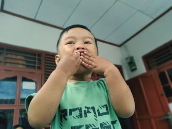 Portrait of boy holding camera