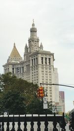 Man by building against sky