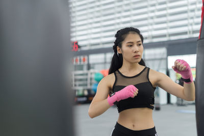 Young woman exercising at gym